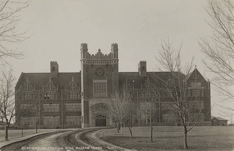 historic sepia photograph depicting a formal brick and stone building in the College Gothic style